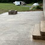 Stone patio with steps and fire pit.
